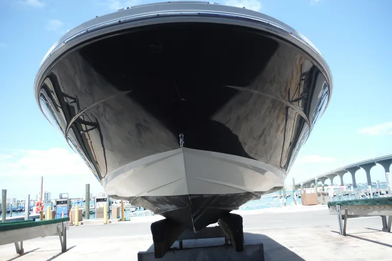Slide: The Image of 2005 Sea Ray 220 Sundeck boat on dry dock, marina background. - 4