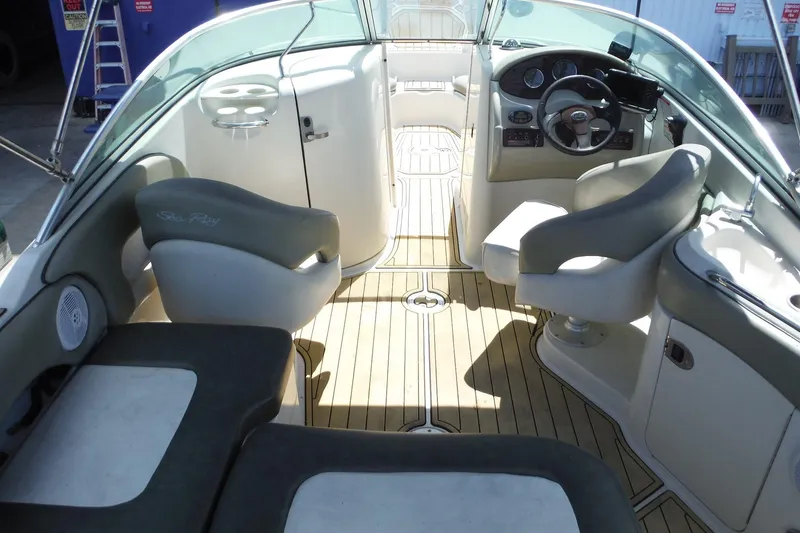 Slide: The Image of Interior of a 2005 Sea Ray 220 Sundeck boat with seating and steering wheel. - 7