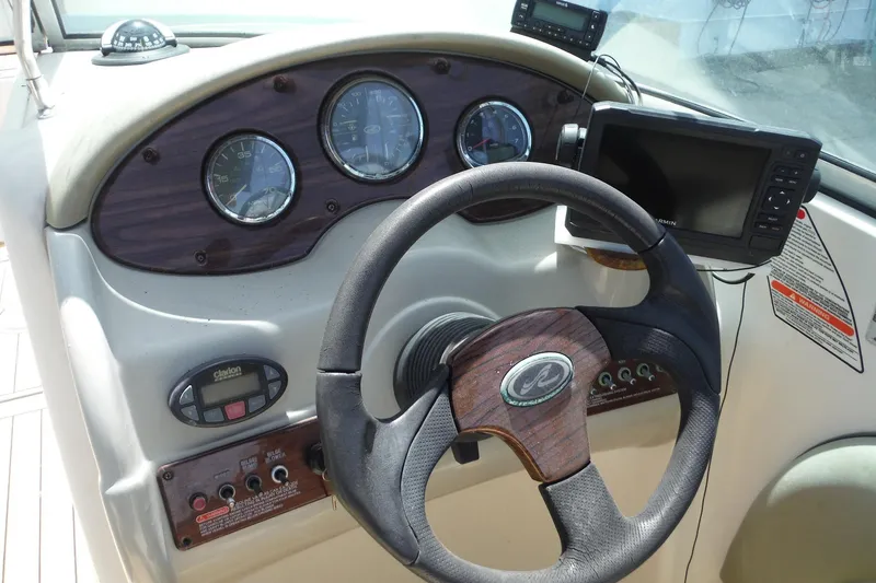Slide: The Image of Steering console of a 2005 Sea Ray 220 Sundeck boat with gauges and navigation equipment. - 8