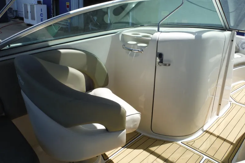 Slide: The Image of Interior of a 2005 Sea Ray 220 Sundeck boat, featuring seating and cup holders. - 9