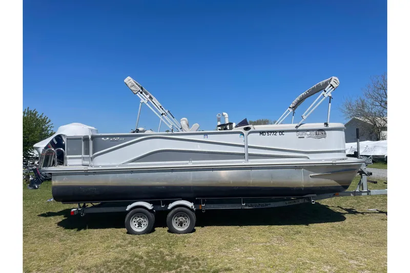 The Image of 2020 SunCatcher V 22 RF pontoon boat on trailer under clear blue sky. - 1