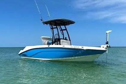 The Image of 2022 Yamaha Boats 190 FSH Sport on calm water under clear blue sky. - 0