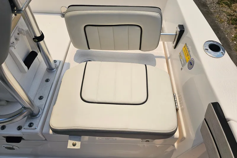 Slide: The Image of 2022 Yamaha Boats 190 FSH Sport seating area with white cushioned seats. - 16