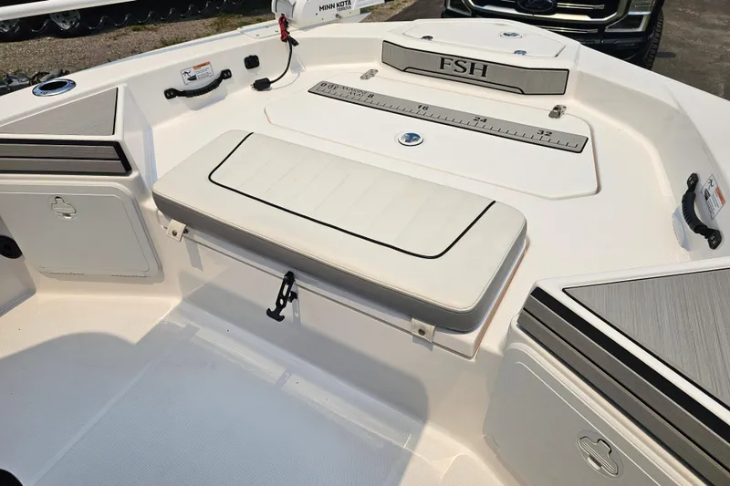 Slide: The Image of 2022 Yamaha Boats 190 FSH Sport interior with seating and storage compartments. - 18
