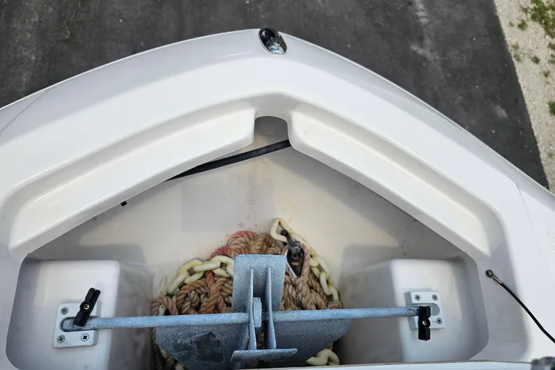 Slide: The Image of Bow storage area of 2022 Yamaha Boats 190 FSH Sport with anchor and rope. - 22