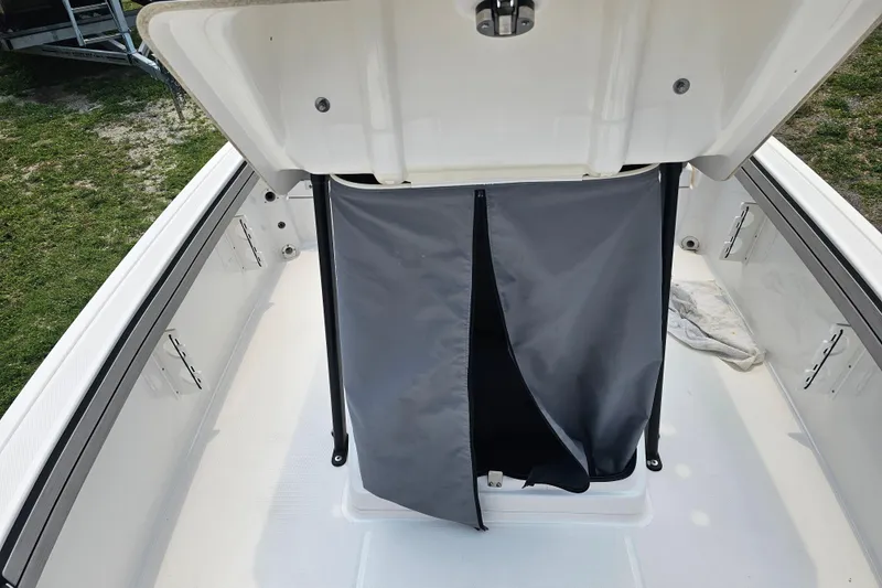 Slide: The Image of 2022 Yamaha Boats 190 FSH Sport storage compartment with open hatch and cover. - 23