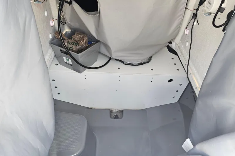 Slide: The Image of Interior of 2022 Yamaha Boats 190 FSH Sport, featuring storage and equipment area. - 25