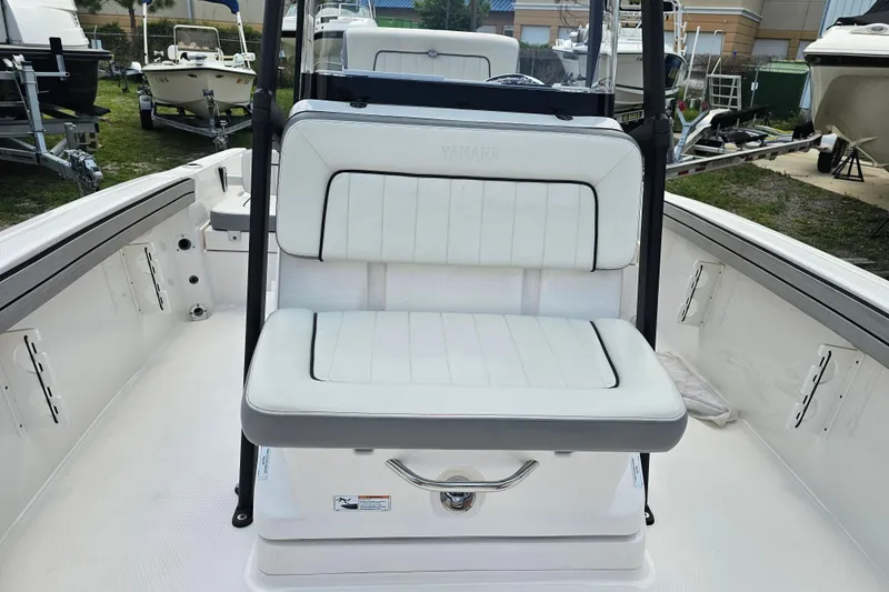 Slide: The Image of 2022 Yamaha Boats 190 FSH Sport interior with white seating and sleek design. - 26