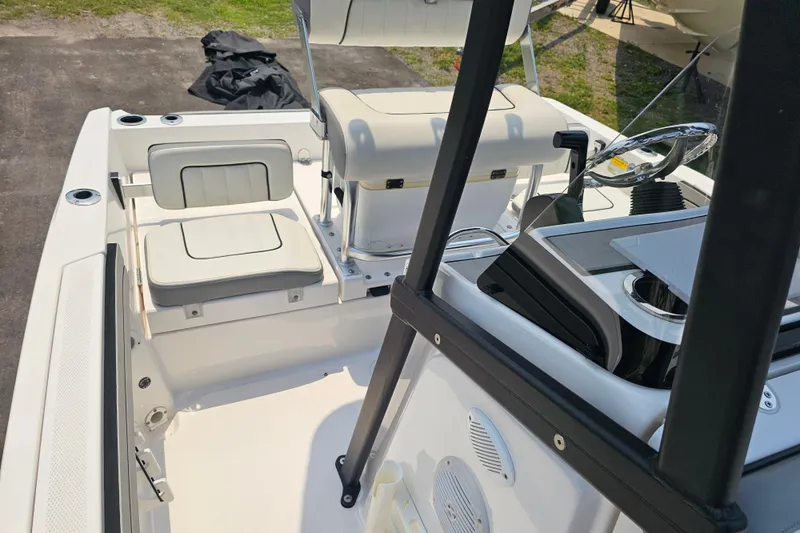 Slide: The Image of 2022 Yamaha Boats 190 FSH Sport interior with seating and steering console. - 30