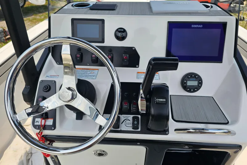 Slide: The Image of 2022 Yamaha Boats 190 FSH Sport dashboard with steering wheel and control panel. - 31