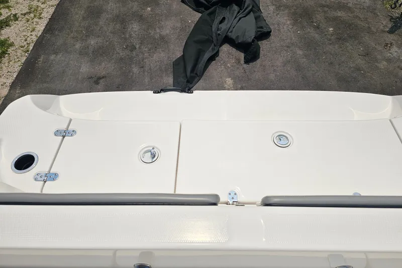Slide: The Image of 2022 Yamaha Boats 190 FSH Sport deck view with storage compartments. - 34