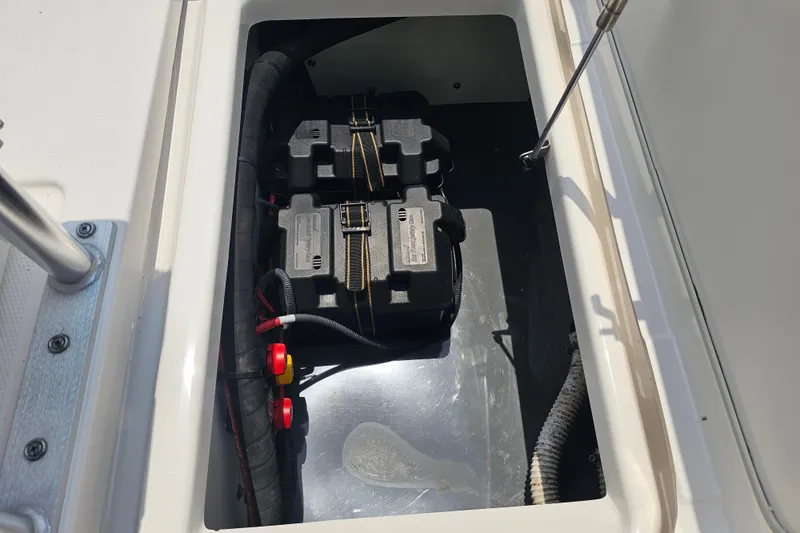 Slide: The Image of Battery compartment of 2022 Yamaha Boats 190 FSH Sport, featuring secure battery storage. - 38