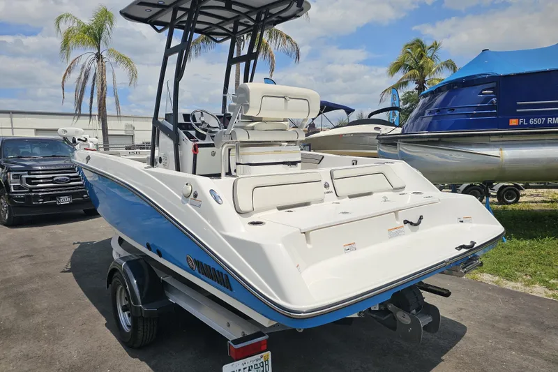 Slide: The Image of 2022 Yamaha Boats 190 FSH Sport in a marina setting, showcasing sleek design and modern features. - 8