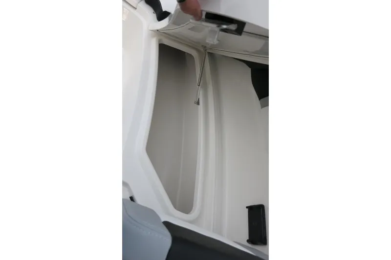 Slide: The Image of 2026 Robalo R300 Center Console storage compartment detail with open hatch. - 10