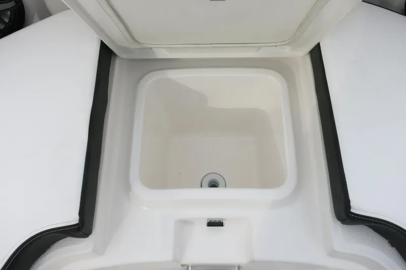 Slide: The Image of 2026 Robalo R300 Center Console boat storage compartment, open and empty. - 11