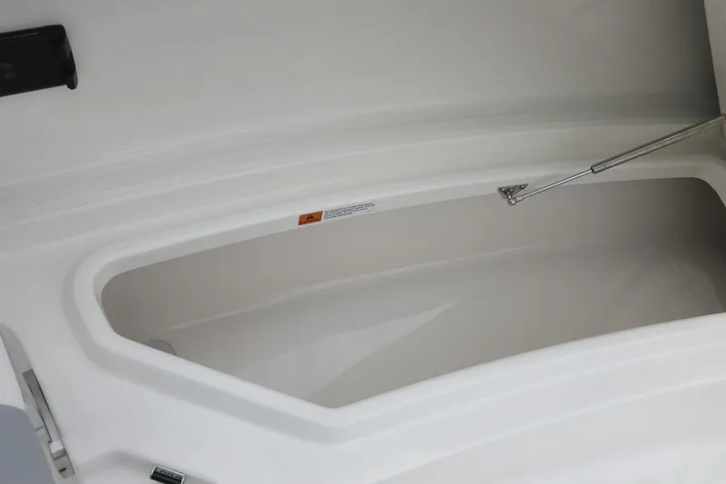 Slide: The Image of 2026 Robalo R300 Center Console storage compartment with hydraulic lift support. - 12