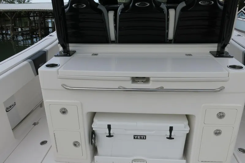 Slide: The Image of 2026 Robalo R300 Center Console boat interior with storage and Yeti cooler. - 22