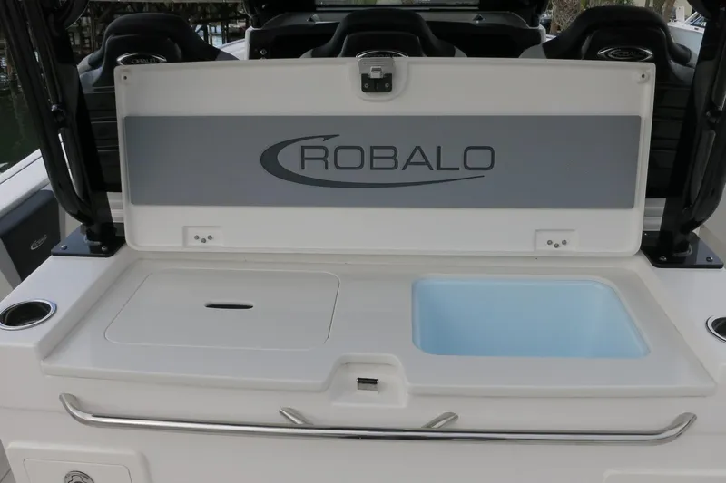 Slide: The Image of 2026 Robalo R300 Center Console boat with open storage compartment. - 24