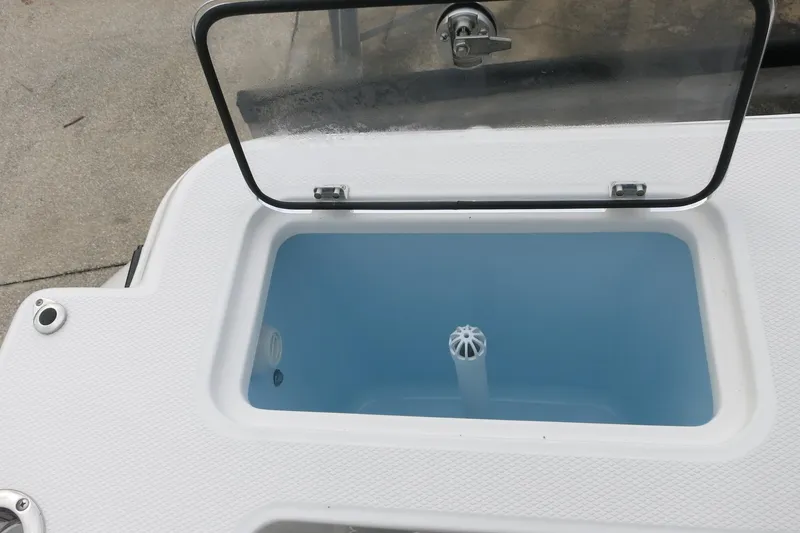 Slide: The Image of Open storage compartment on 2026 Robalo R300 Center Console boat. - 28