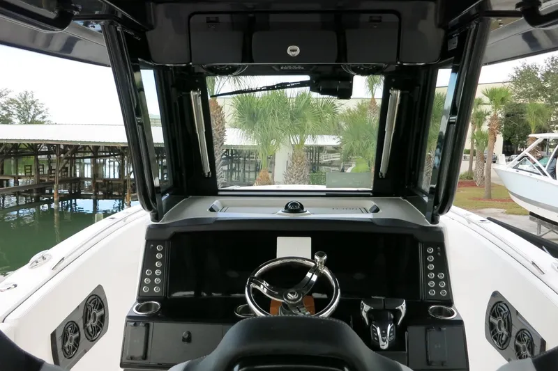 Slide: The Image of 2026 Robalo R300 Center Console boat interior with steering wheel and control panel. - 31
