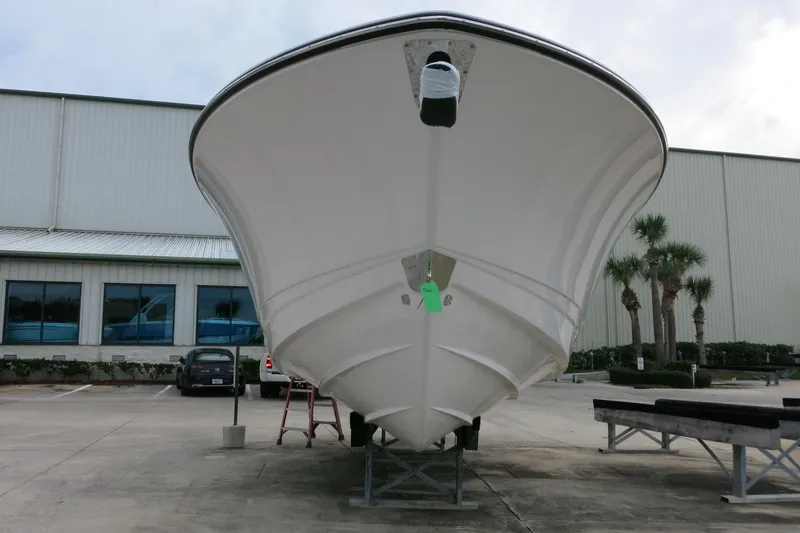 Slide: The Image of 2026 Robalo R300 Center Console boat on display outside a warehouse. - 33