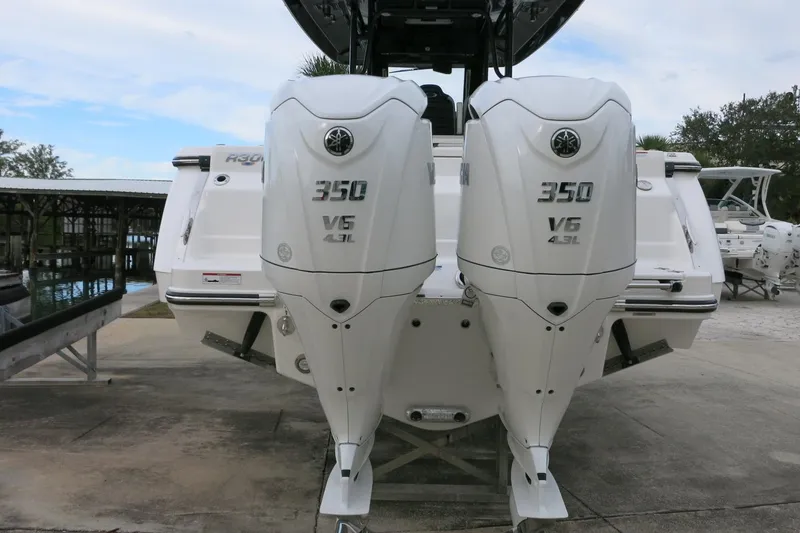 Slide: The Image of 2026 Robalo R300 Center Console with twin 350 V6 engines at a marina. - 5