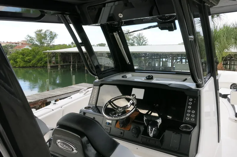 Slide: The Image of 2026 Robalo R300 Center Console boat dashboard with steering wheel and controls. - 7