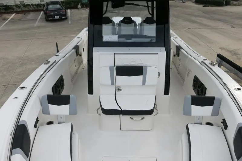 Slide: The Image of 2026 Robalo R300 Center Console boat interior with seating and console view. - 9