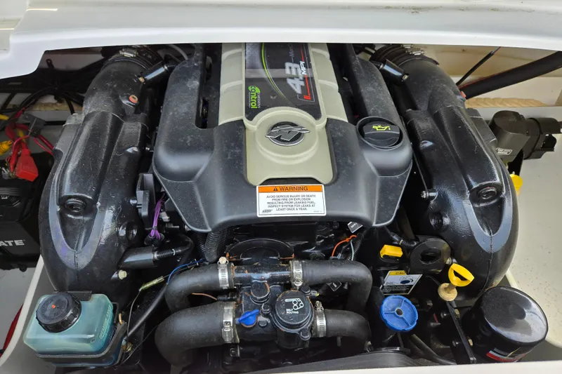 Slide: The Image of Engine of a 2014 Crownline 21 SS boat, showcasing detailed components. - 12