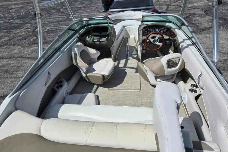 Slide: The Image of 2014 Crownline 21 SS boat interior with seating and steering wheel. - 13