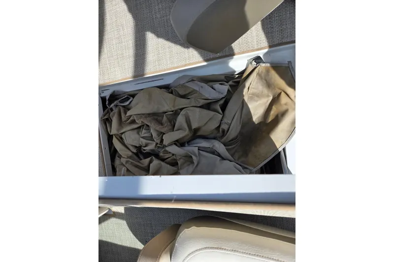 Slide: The Image of Storage compartment with fabric inside a 2014 Crownline 21 SS boat. - 17