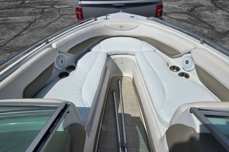Slide: The Image of 2014 Crownline 21 SS boat interior with white seating and cup holders. - 18