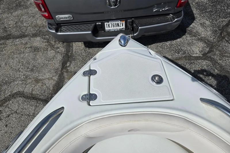 Slide: The Image of Bow of 2014 Crownline 21 SS boat near a parked truck. - 19