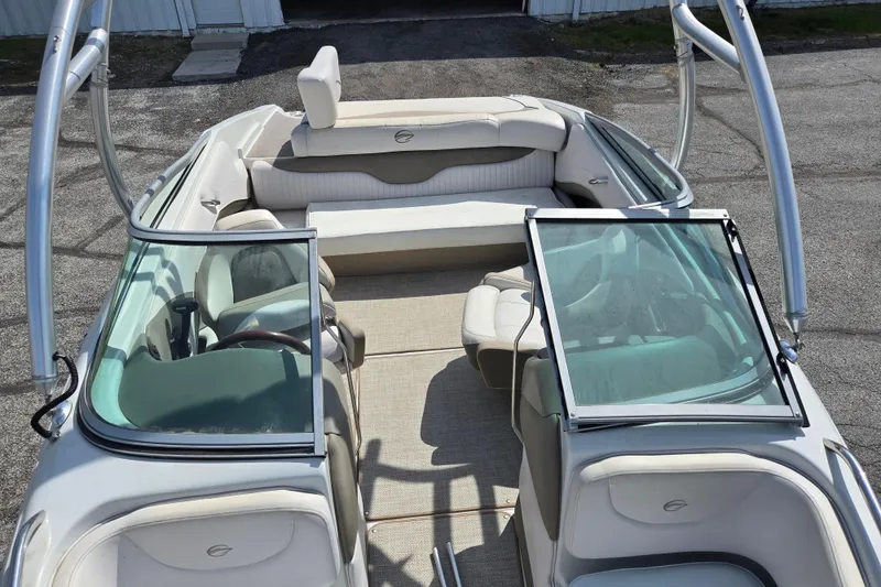 Slide: The Image of 2014 Crownline 21 SS boat interior with open windshield and seating. - 21
