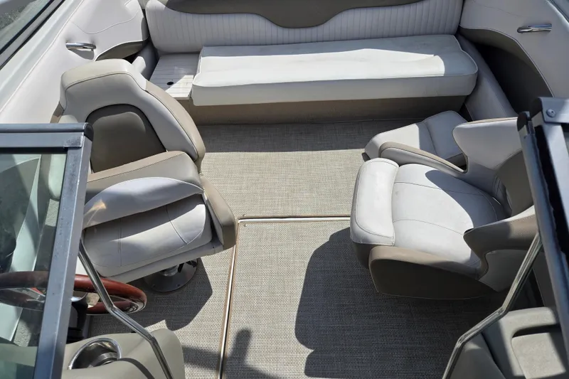 Slide: The Image of Interior of 2014 Crownline 21 SS boat with seating and steering wheel. - 22