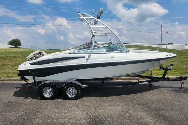 Slide: The Image of 2014 Crownline 21 SS boat on trailer under a cloudy sky. - 4