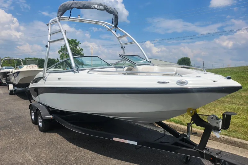 Slide: The Image of 2014 Crownline 21 SS boat on trailer, sunny day, blue sky background. - 5