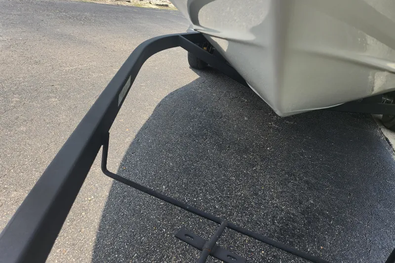 Slide: The Image of 2014 Crownline 21 SS boat on trailer, parked on asphalt surface. - 7