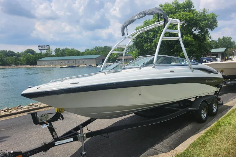 Slide: The Image of 2014 Crownline 21 SS boat on trailer by a scenic waterfront. - 8
