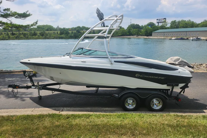 Slide: The Image of 2014 Crownline 21 SS boat on trailer by a scenic waterfront. - 9