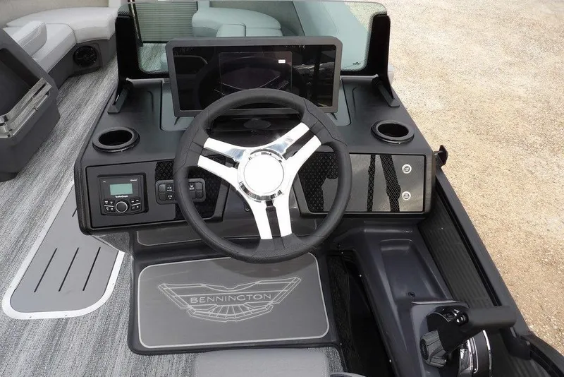 Slide: The Image of 2026 Bennington M L-Bench 22 ML boat dashboard with steering wheel and controls. - 24
