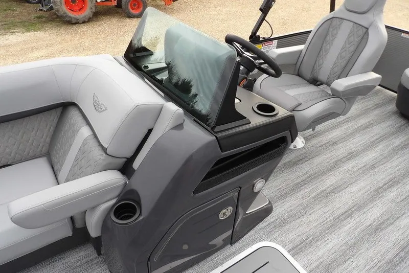 Slide: The Image of 2026 Bennington M L-Bench 22 ML boat interior with gray seating and steering console. - 26