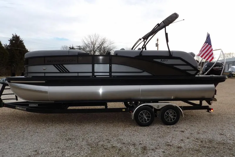 Slide: The Image of 2026 Bennington M L-Bench 22 ML pontoon boat on trailer with American flag. - 5
