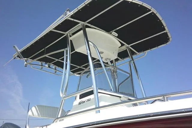 Slide: The Image of 2010 Sea Hunt Triton 202 boat with T-top against clear blue sky. - 11