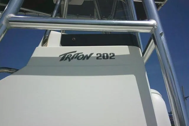 Slide: The Image of 2010 Sea Hunt Triton 202 boat, close-up view of model name on hull. - 12