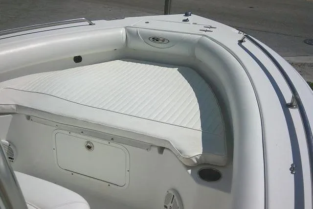 Slide: The Image of 2010 Sea Hunt Triton 202 boat interior with white cushioned seating. - 13