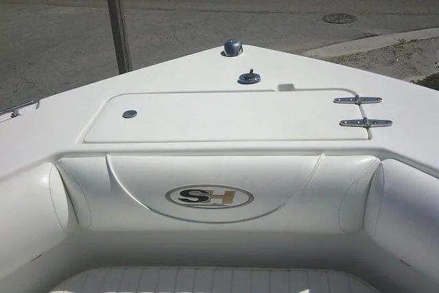 Slide: The Image of 2010 Sea Hunt Triton 202 boat interior with storage compartment and SH logo. - 14