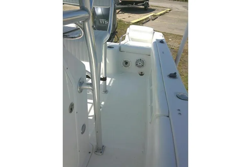 Slide: The Image of 2010 Sea Hunt Triton 202 boat interior with Yamaha 115 engine, white seating, and clean deck. - 19