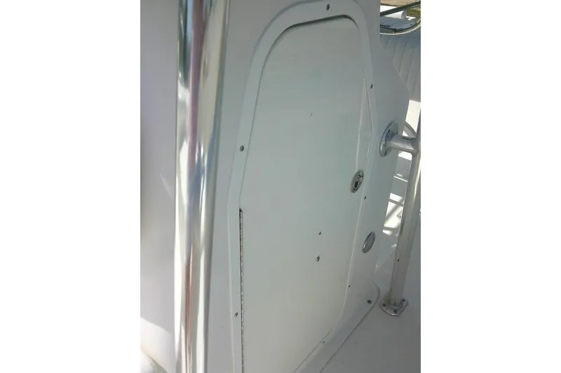 Slide: The Image of 2010 Sea Hunt Triton 202 boat interior detail with white panel and chrome handle. - 20