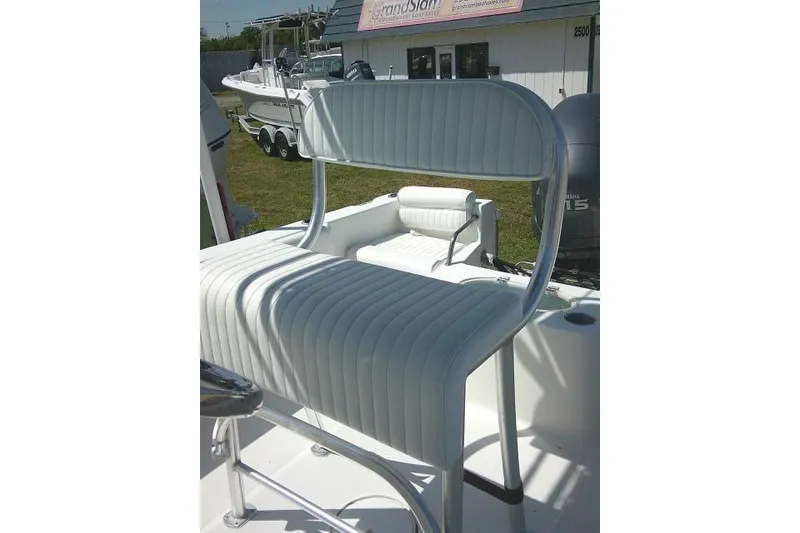 Slide: The Image of 2010 Sea Hunt Triton 202 boat with white cushioned seating and Yamaha engine. - 21